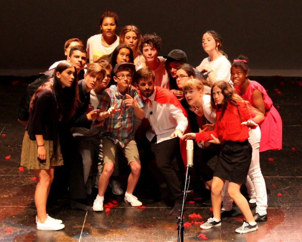 Students standing around a microphone